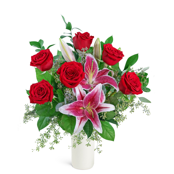 Red roses and pink lilies arranged in a white vase