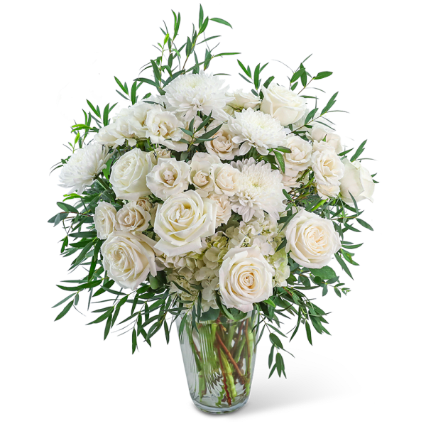 White roses and chrysanthemums in a clear glass vase