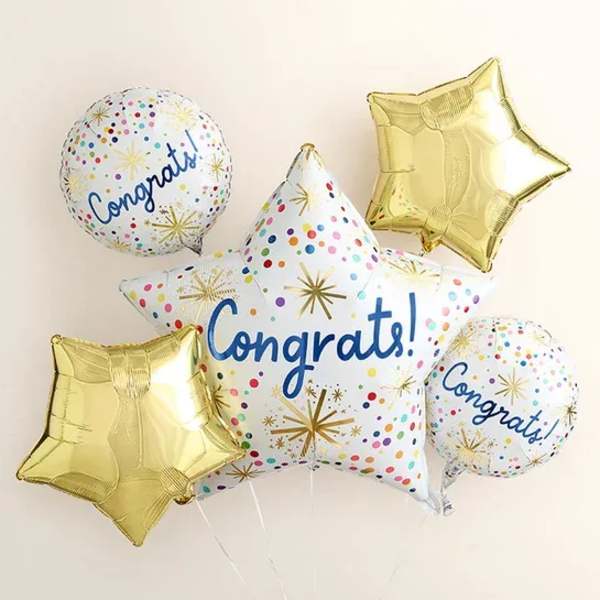 Cluster of congratulatory star-shaped and round balloons