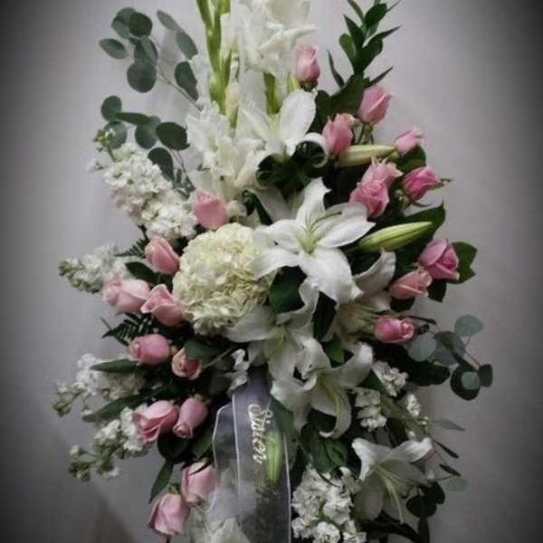 Tall standing floral spray with white lilies and pink roses