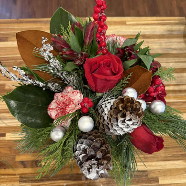 Holiday bouquet with red roses, carnations, pinecones, and ornaments