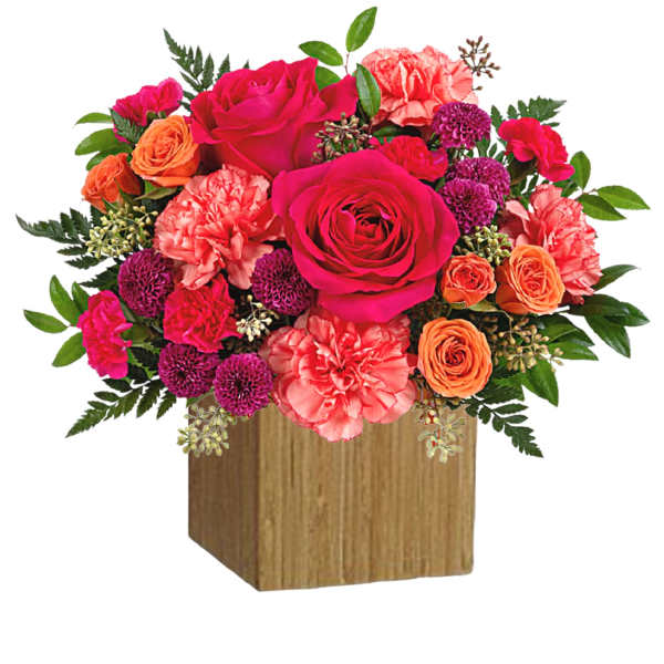 Bright mixed bouquet of roses and carnations in a wooden cube vase