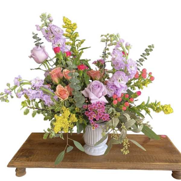 Mixed bouquet in a white vase with lavender, peach, pink, and yellow flowers