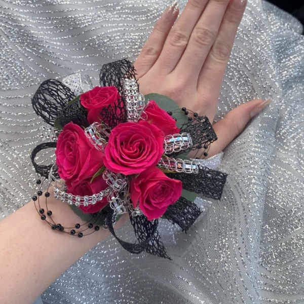 Pink rose wrist corsage with black and silver ribbon accents