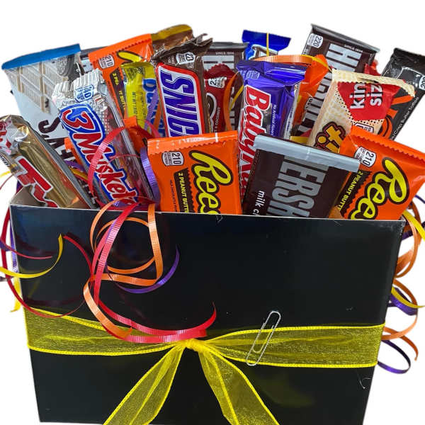 Gift box filled with assorted candy bars and ribbon