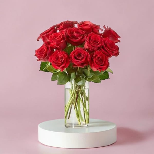 Red roses arranged in a clear glass vase