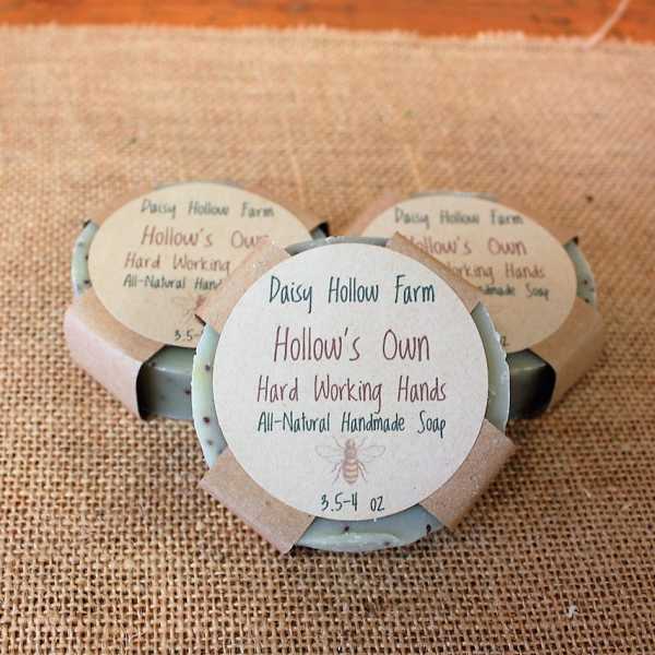 Three bars of handmade soap with paper labels on burlap