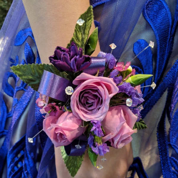 Purple and pink wrist corsage with roses and ribbon