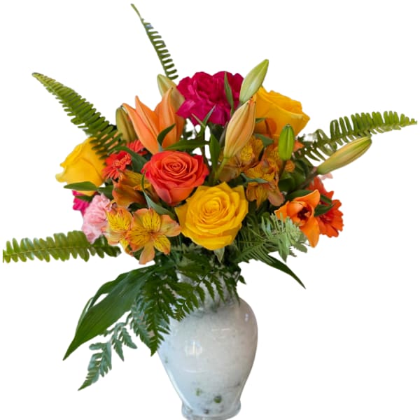 Colorful bouquet of roses, lilies, and daisies in a white vase