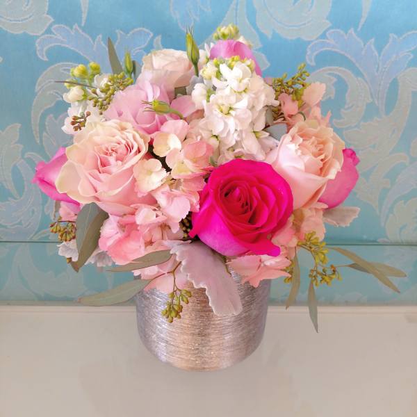 Pink and white rose bouquet in a silver vase