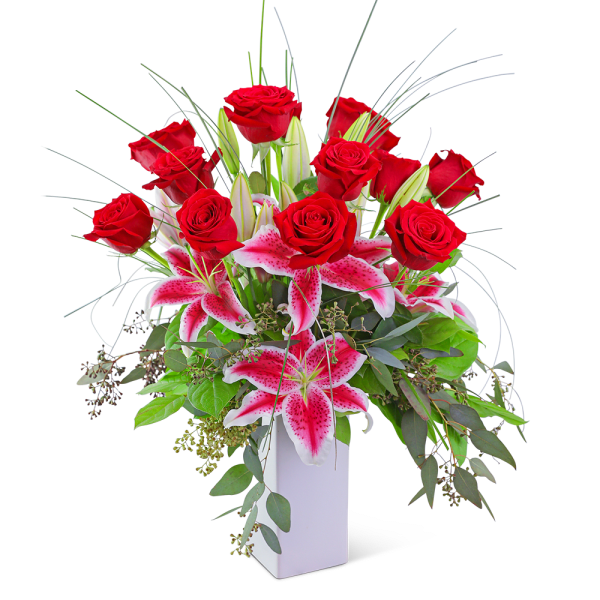 Red roses and pink lilies in a white vase