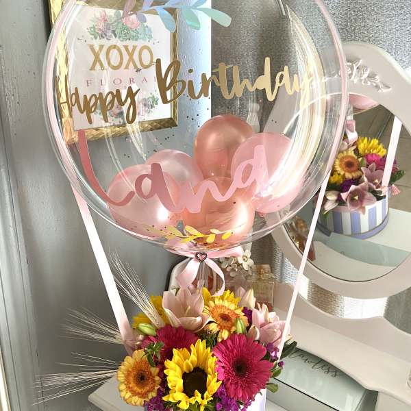 Birthday balloon with pink flowers in a striped box