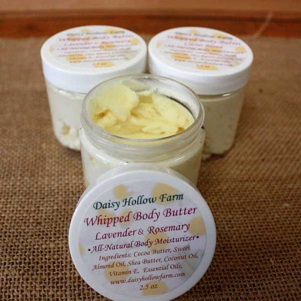 Three jars of whipped body butter on burlap, one open in front