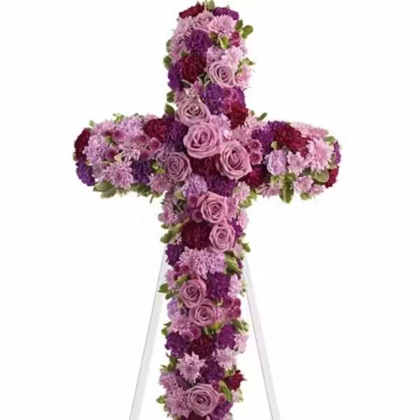 Purple and pink floral cross on a white stand