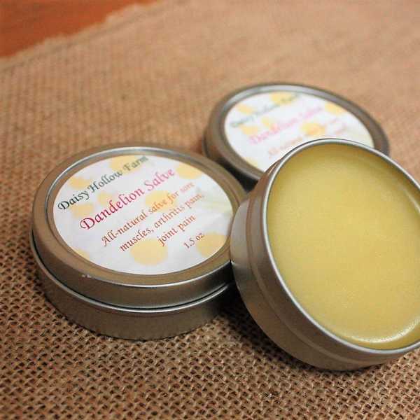 Three tins of yellow salve on burlap fabric
