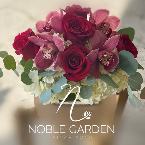 Bouquet of red roses and pink orchids with pale hydrangeas