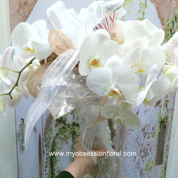 White orchid bouquet with ribbon and sheer wrap