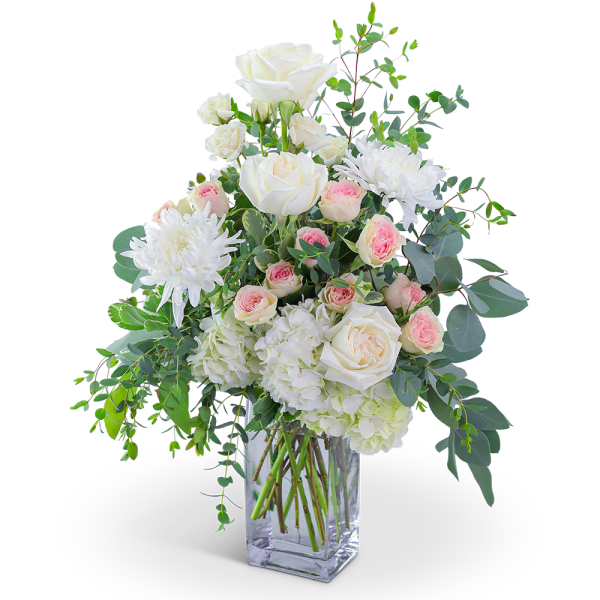 White roses and chrysanthemums in a clear glass vase