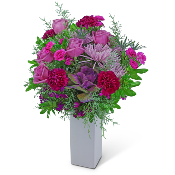 Pink roses and magenta carnations in a white vase