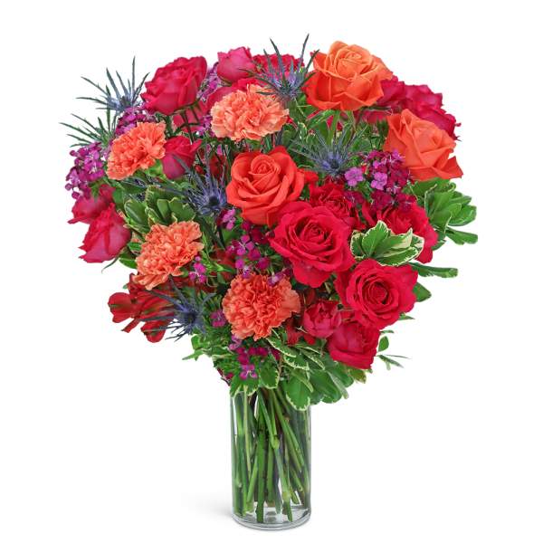 Mixed bouquet of red and orange roses in a clear glass vase