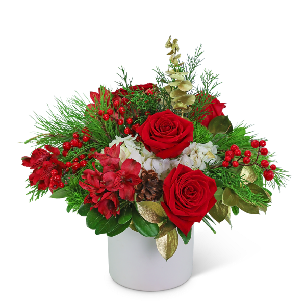 Red roses and red flowers in a white vase with pine and berries