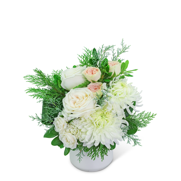 White and blush flowers arranged in a white vase