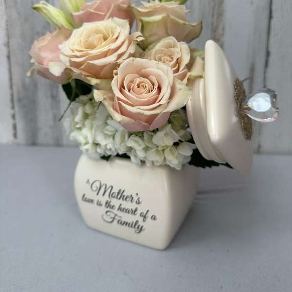 Cream roses and lilies in a heart-shaped keepsake box with a Mother's Day message