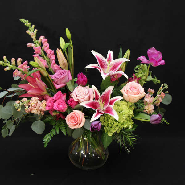 Pink and white mixed flower arrangement in a glass vase