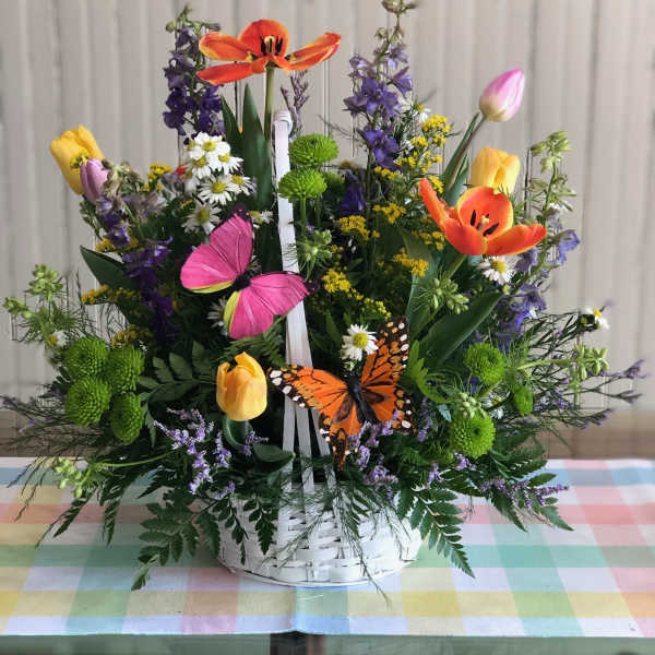 Colorful flower basket with tulips, daisies, and butterflies