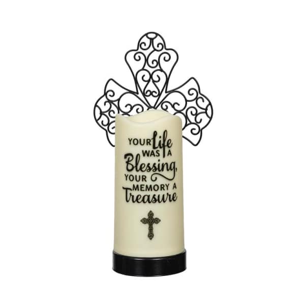 Memorial candle with a decorative cross topper
