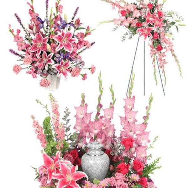 Pink and red floral funeral tribute with a silver urn centerpiece