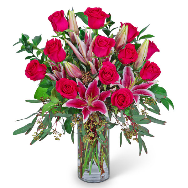 Pink roses and stargazer lilies in a clear glass vase