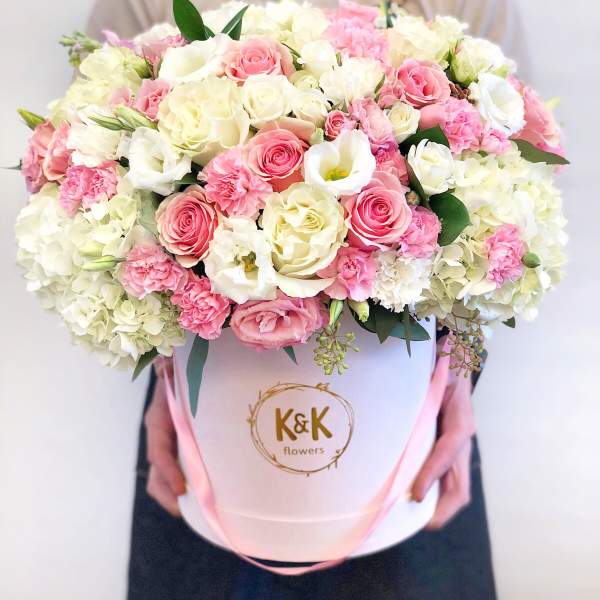 Large bouquet of pink and white roses in a white hat box