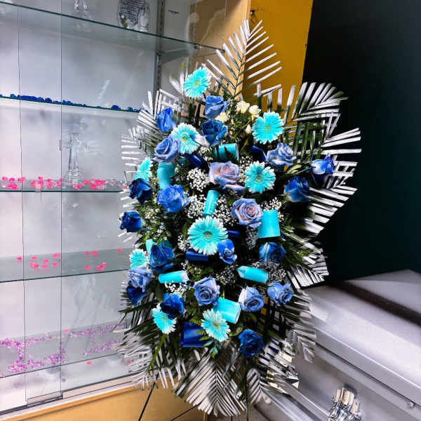 Blue and white floral standing spray on an easel