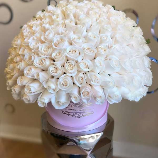 Large bouquet of white roses in a pink round box