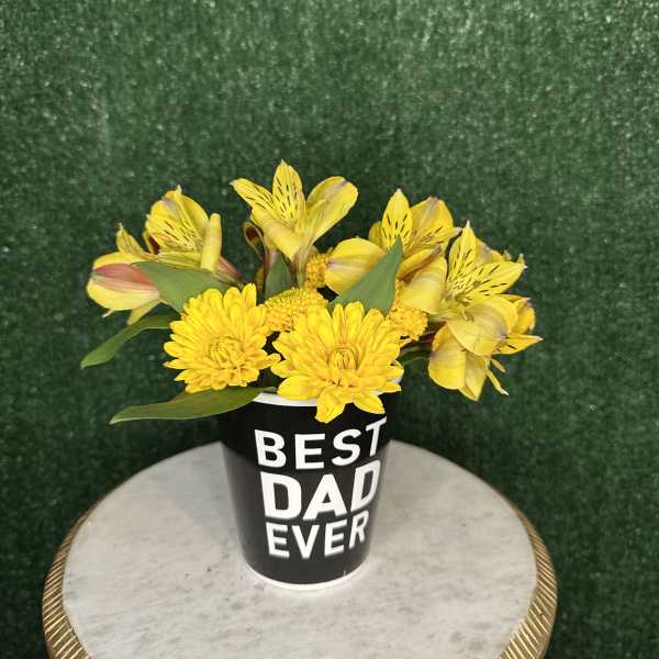 Yellow flowers in a black cup that says "BEST DAD EVER"