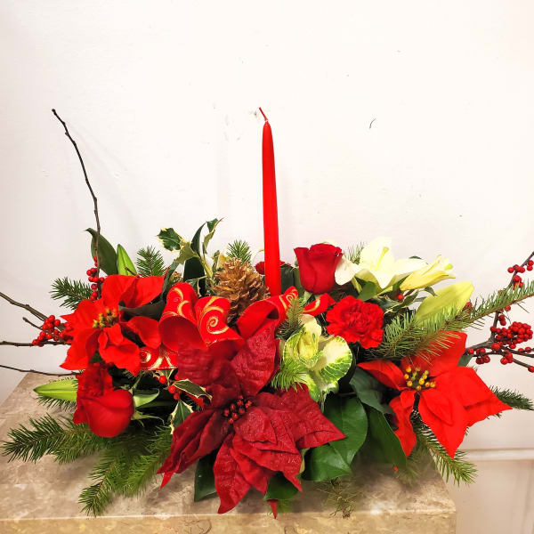 Red and white floral centerpiece with a tall red candle