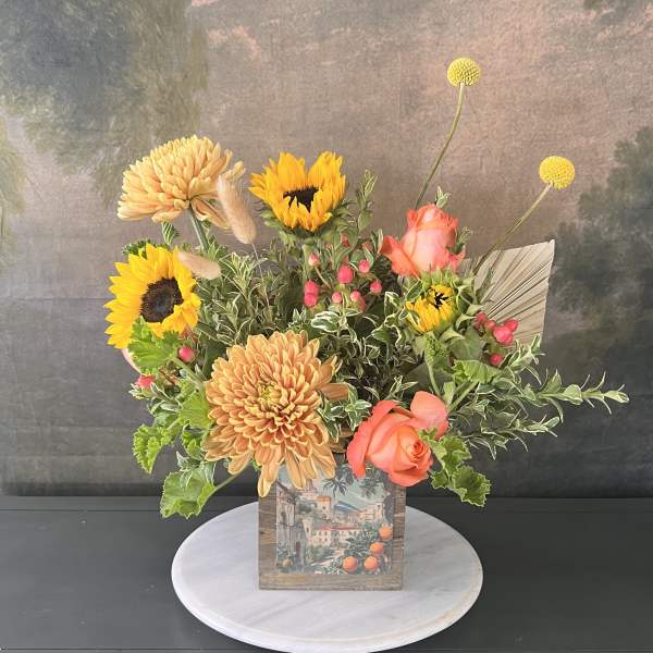 Mixed bouquet with sunflowers, peach chrysanthemums, and coral roses in a decorative box