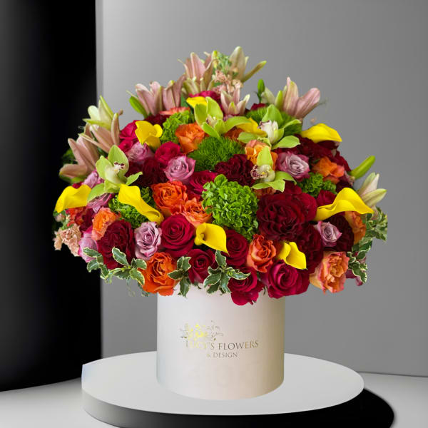 Large mixed bouquet of roses, lilies, and calla lilies in a white hat box