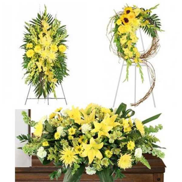Yellow floral funeral arrangements displayed on a casket and easels