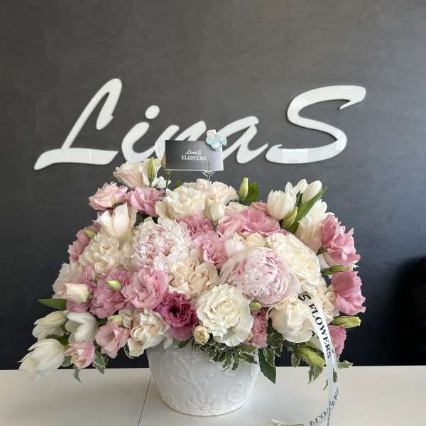 Pink and white floral arrangement in a white vase