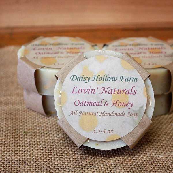 Three wrapped bars of oatmeal and honey soap on burlap