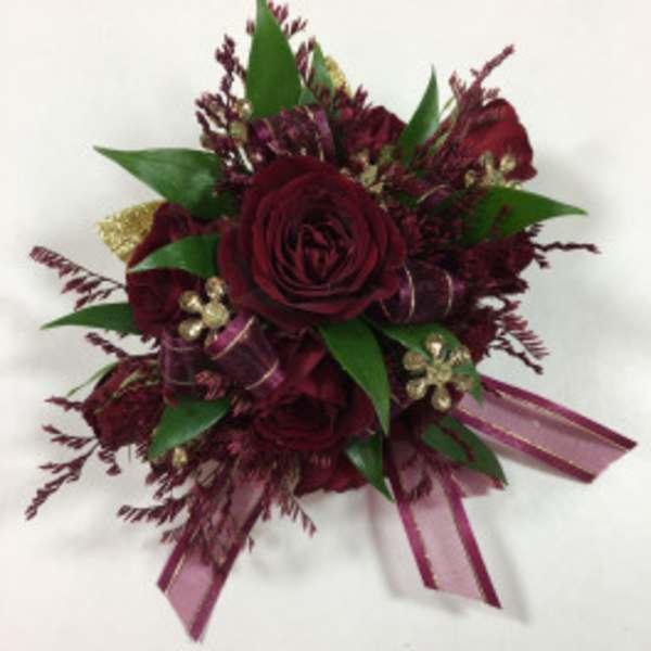 Dark red rose bouquet with green leaves and purple ribbon