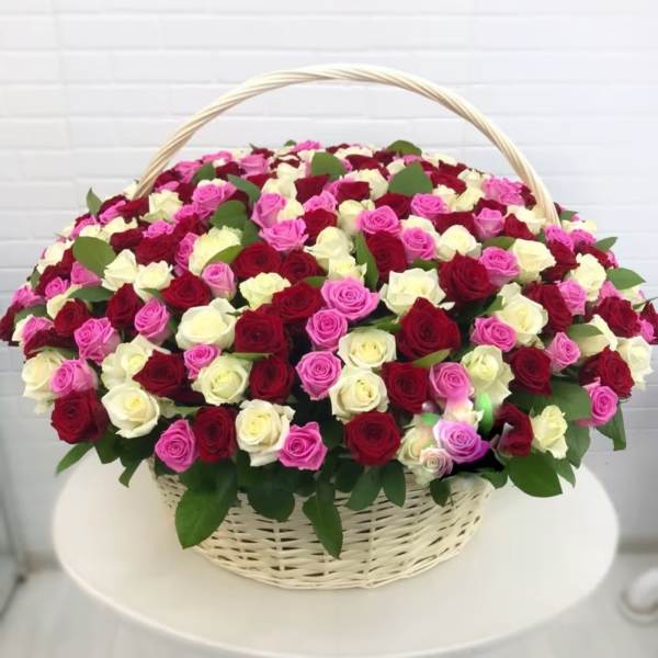 Basket of red, pink, and white roses with a woven handle