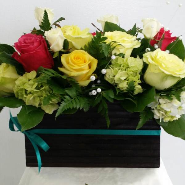 Mixed roses and hydrangeas in a black box with a teal ribbon