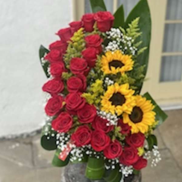 Bouquet of red roses and sunflowers with white filler flowers