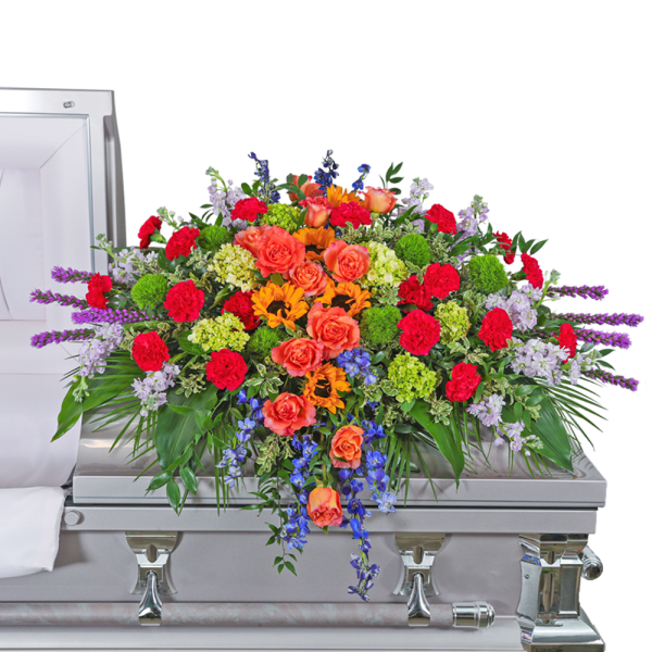 Colorful floral spray on a silver casket