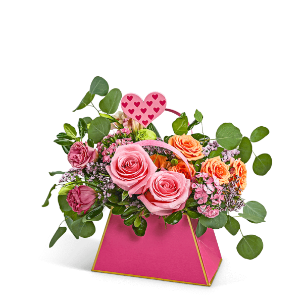 Pink and peach rose arrangement in a bright pink box with a heart pick