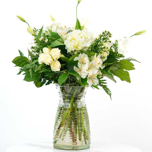 White flowers arranged in a clear glass vase