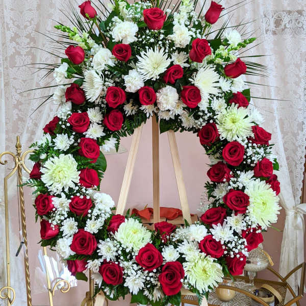 Large red and white floral wreath on an easel